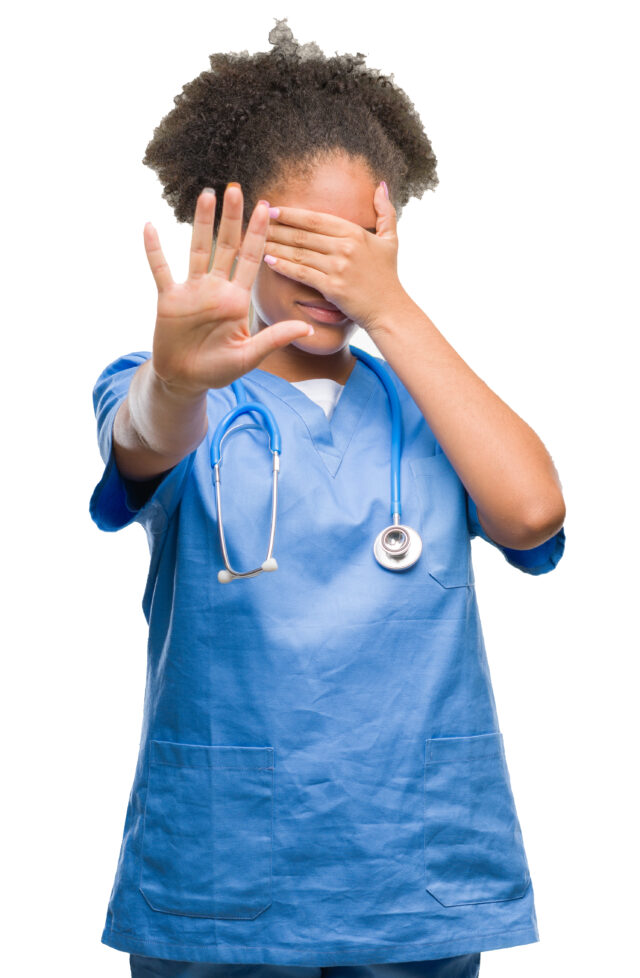 Young afro american doctor woman over isolated background covering eyes with hands and doing stop gesture with sad and fear expression. Embarrassed and negative concept.